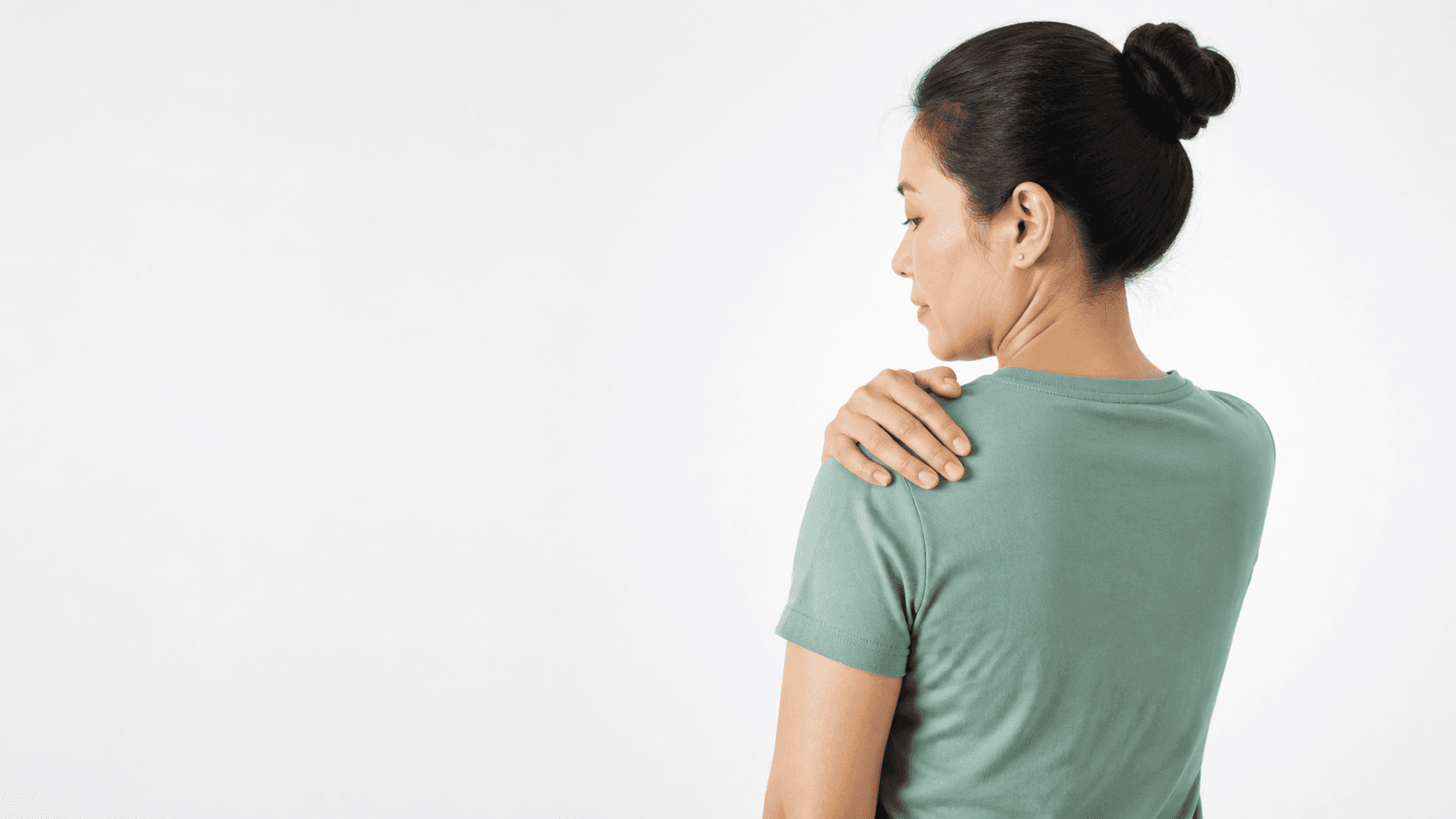 Person gently resting a hand on the opposite shoulder
