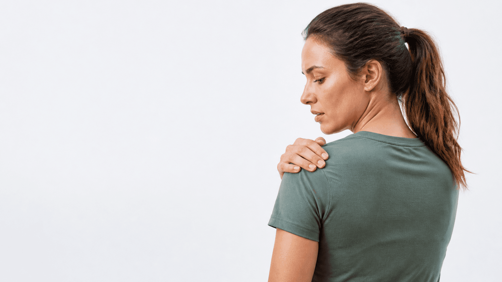 Person gently resting a hand on the outer upper shoulder