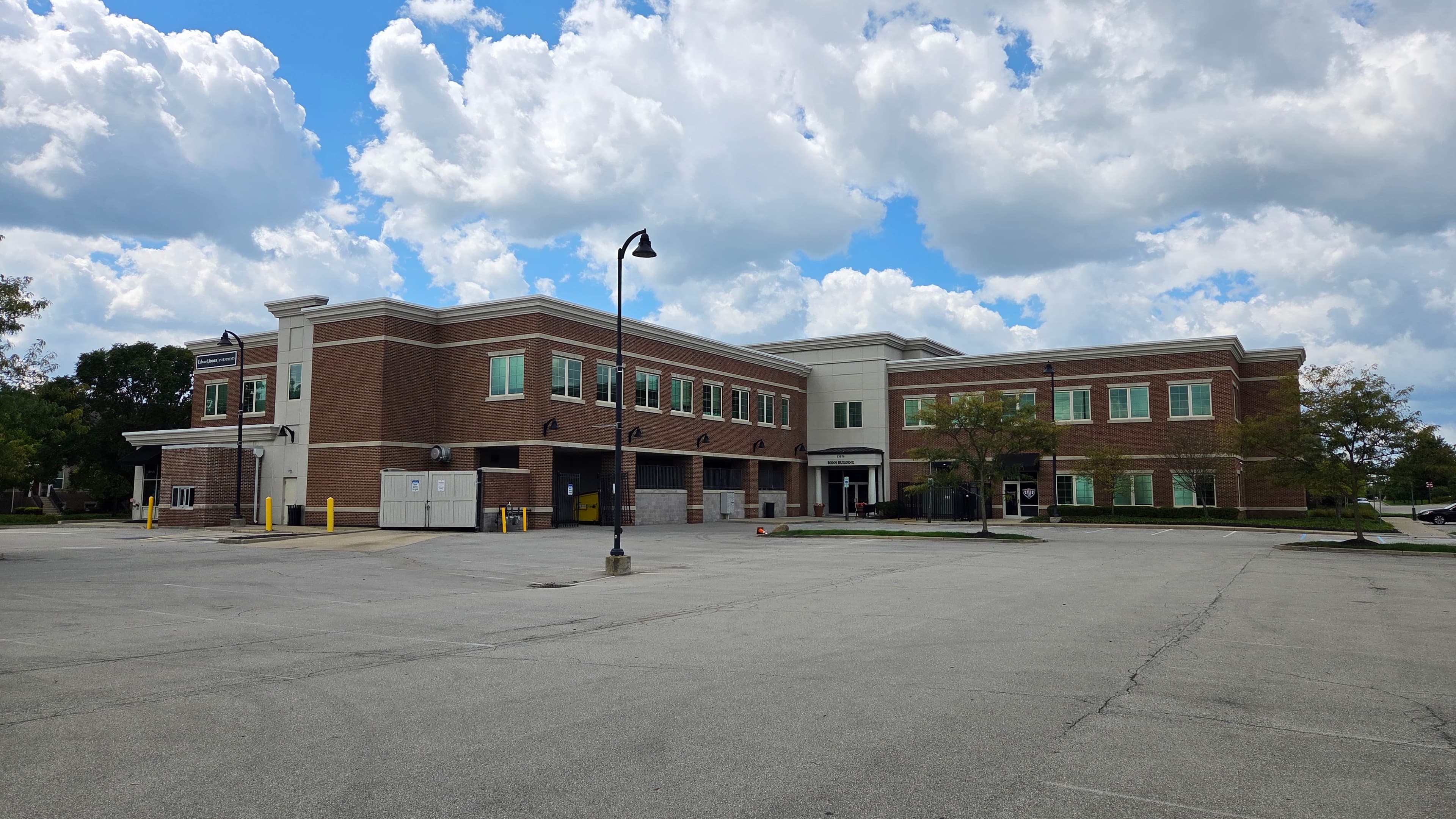 Rear of the Bonn Building viewed across the main parking lot, with Back to Balance on the right side