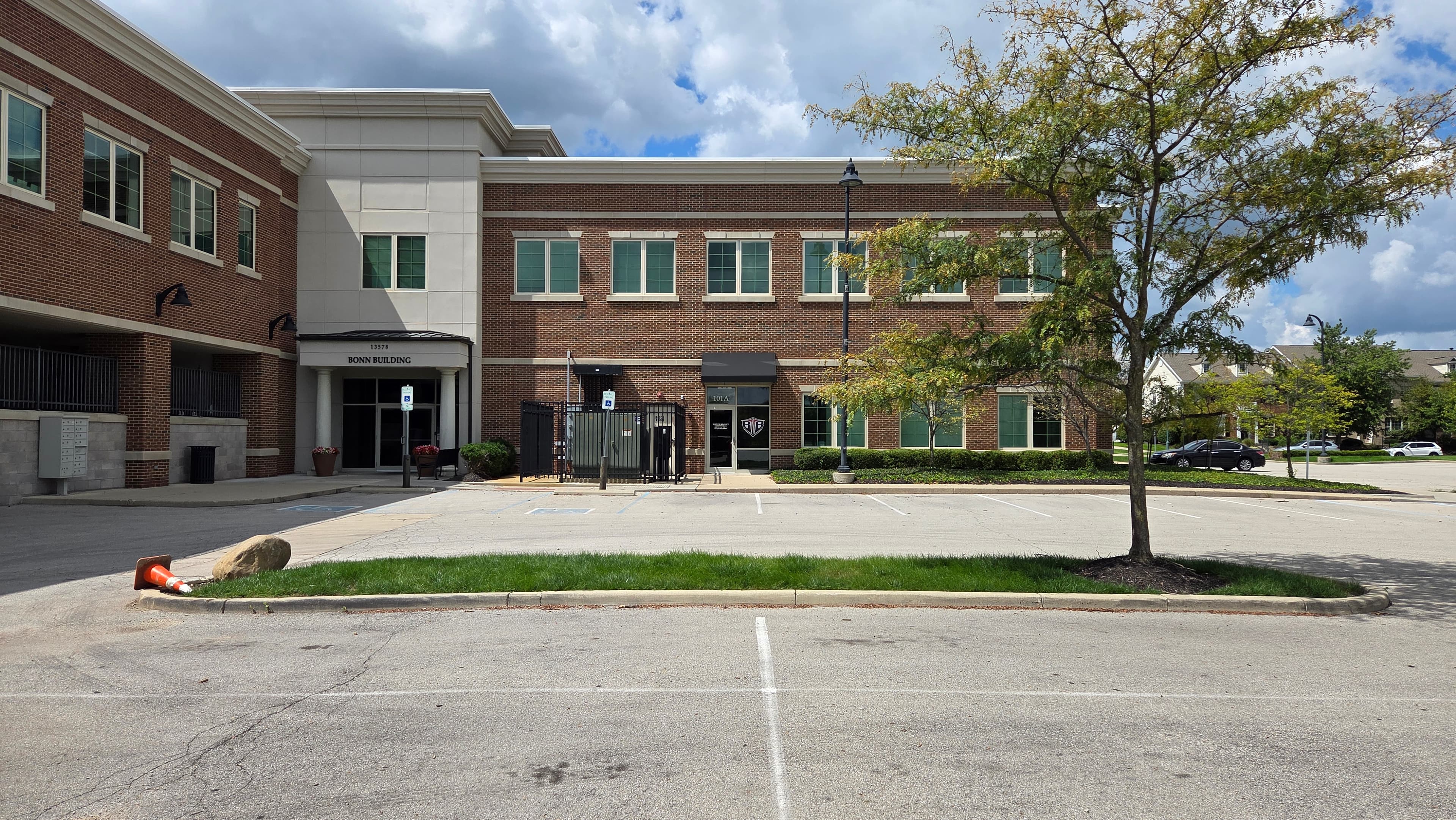 Back to Balance ground-floor entrance situated beside the black fence on the building right wing